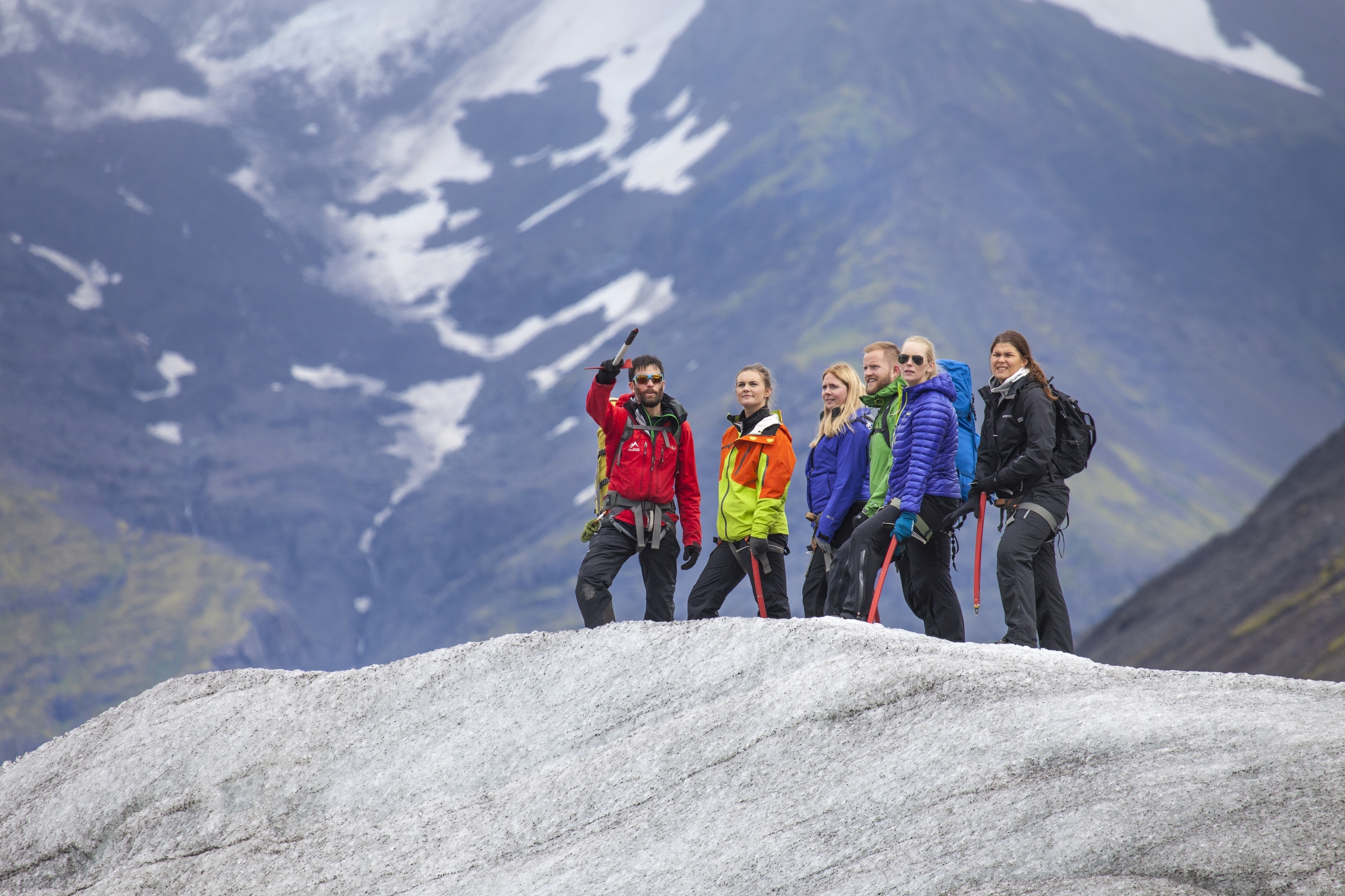 Gletscherwanderung, Gruppe von 5 Menschen begeht zusammen mit Guide einen Gletscher