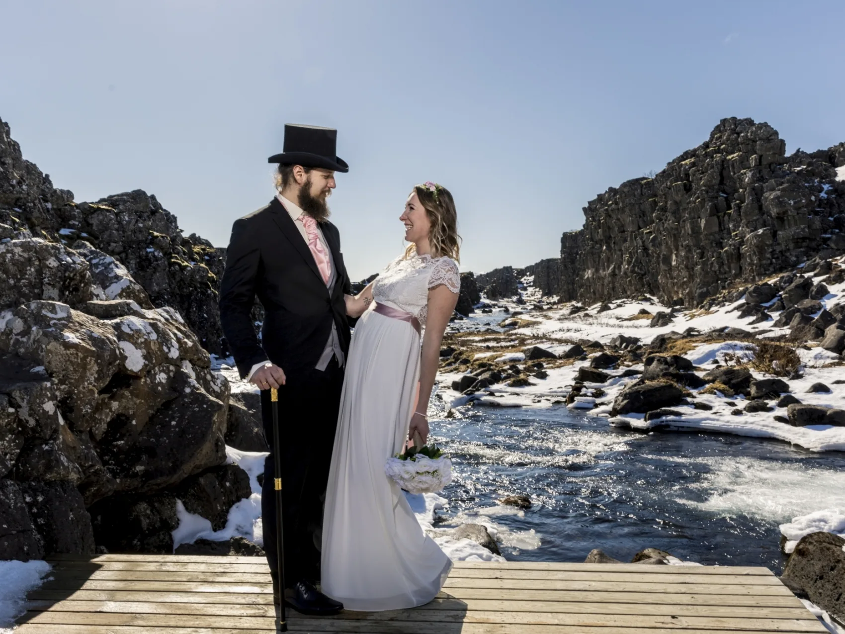 Pärchen in Thingvellir im Winter bei Sonnenschein schaut sich lachend an