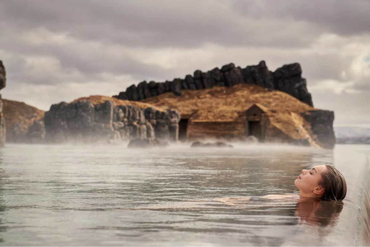 Sky Lagoon, Frau schwimmt im Wasser des Bades